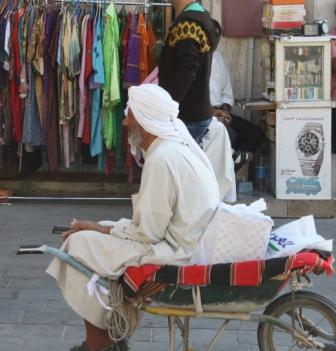 Afghan man, wheelbarrow man, gray beard, shalwar kameez, marketplace, bazaar